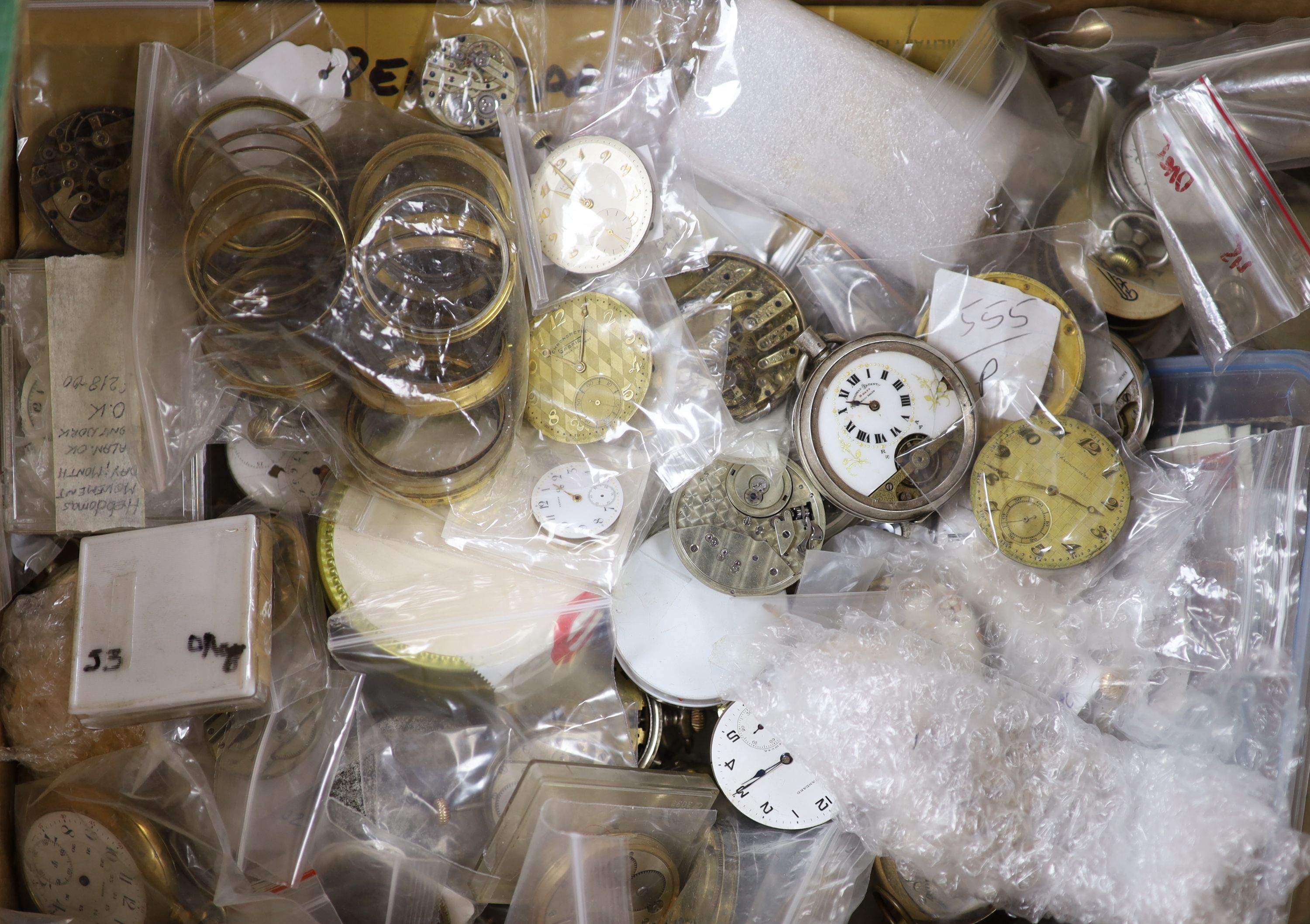 A large quantity of assorted pocket watch movements, parts and accessories
